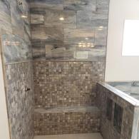 Porcelain tile shower and marble pan shower floor